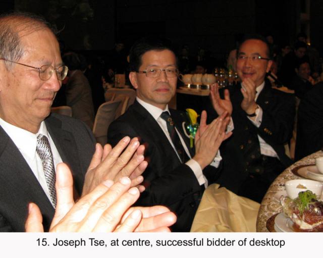 15. Joseph Tse, at centre, successful bidder of desktop